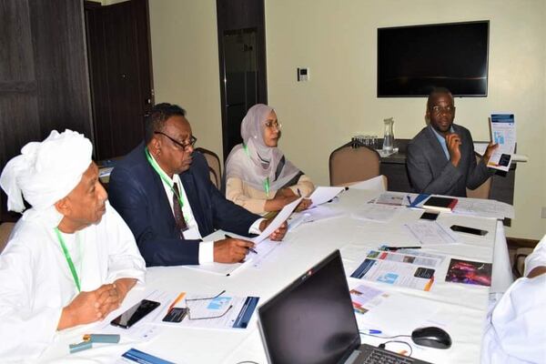 Members of the programme to aid farmers sit at a round table