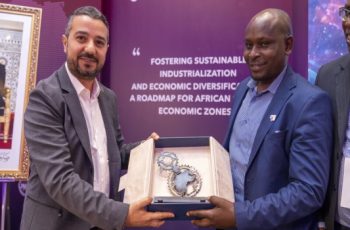 Two TatuCity officials holding the UN Award